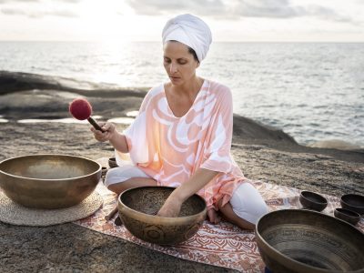 senior-meditation-guide-with-singing-bowls-full-shot